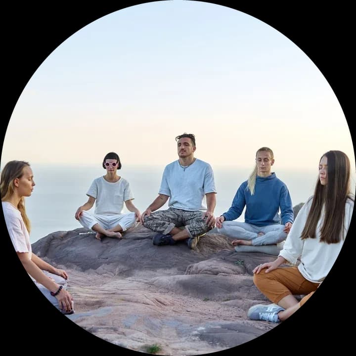 People sitting together in a circle at dawn