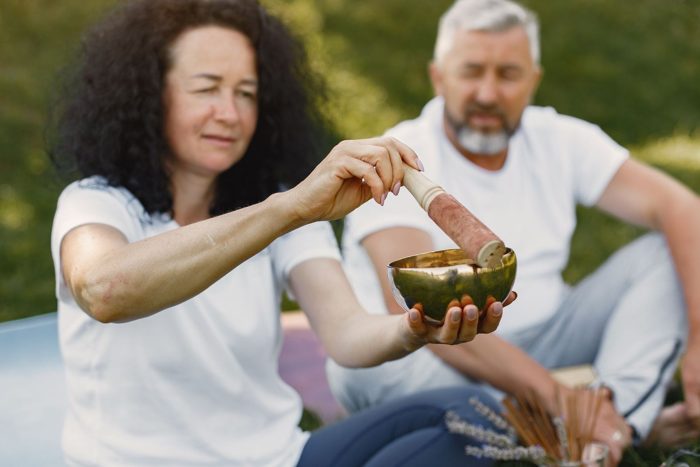 Two people in practice with a singing bowl
