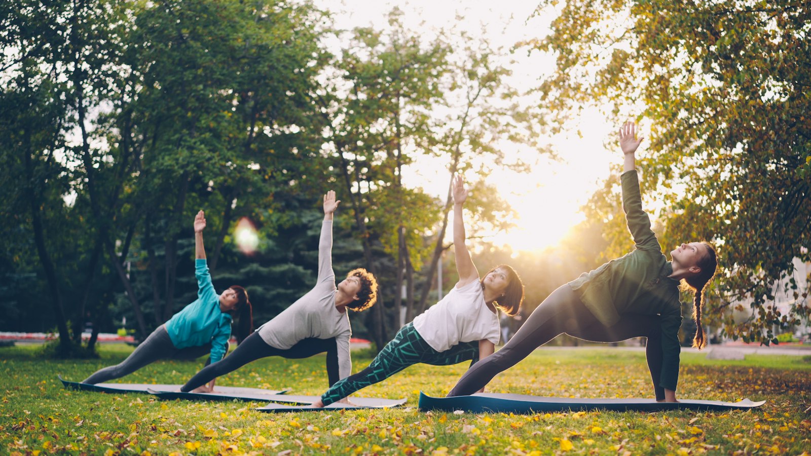 A group practising outdoors at sunset