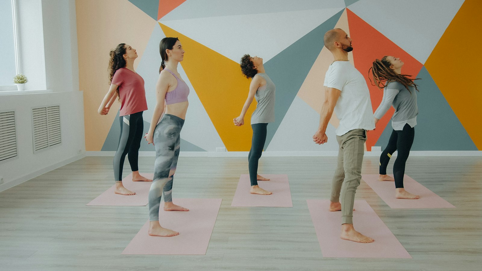 A small group stretching in a studio class