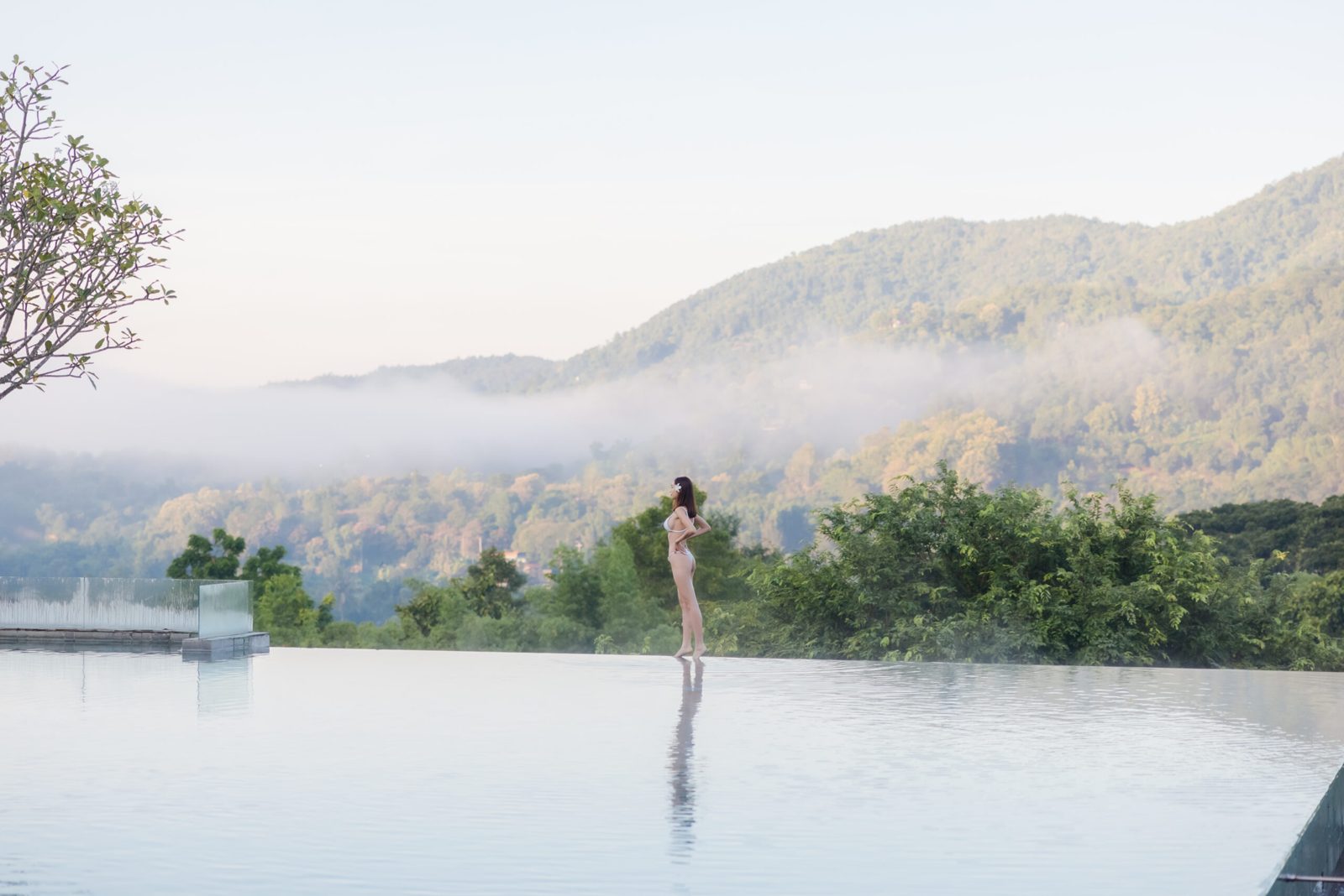 An infinity pool over the misty valley at dawn