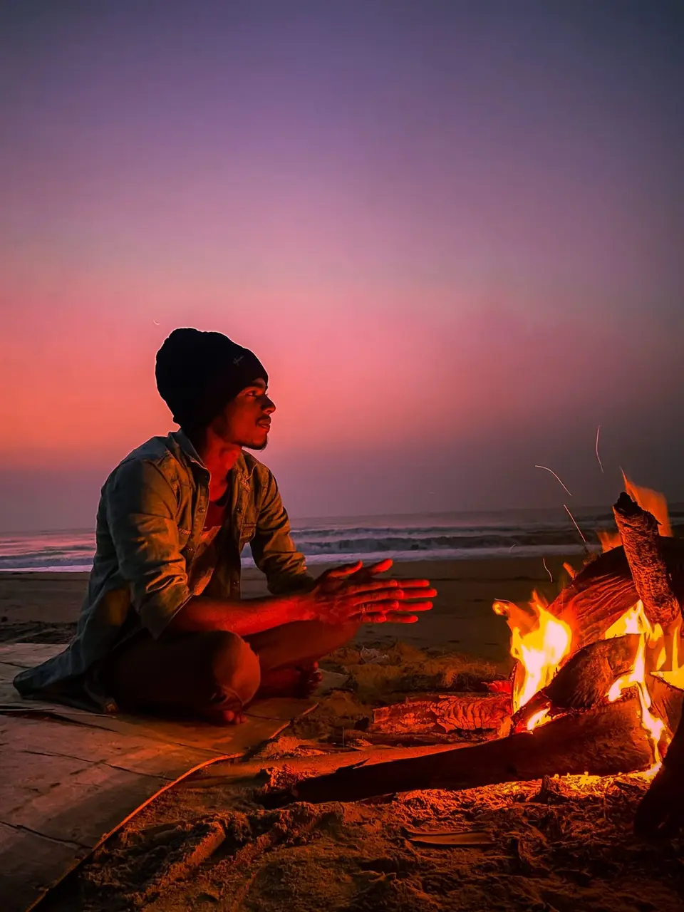 People sitting by a fire in the forest